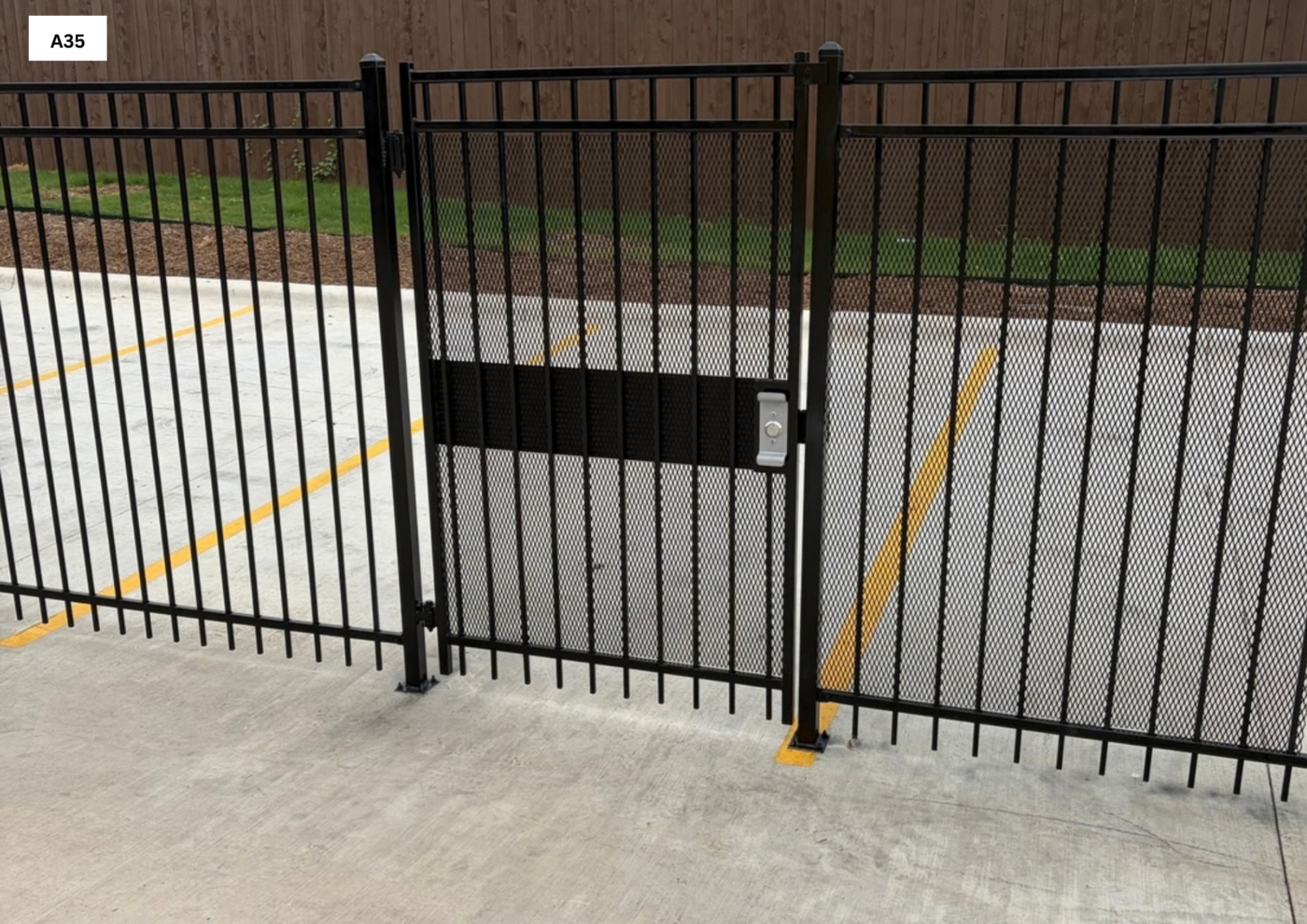 Ameristar 3 rail 6’ Tall Ameristar 3 rail with 2”x 2” post mounted to concrete with a 4”x 4” Base Plate with ADA Free Exit push bar with Expanded metal powder coated Black
